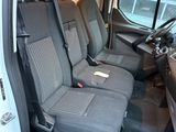 the interior of a white van with four seats and a steering wheel