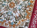 a red and white table cloth with a picture of animals on it