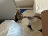 a box full of paper plates and cups on the floor