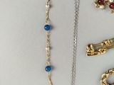 many different types of jewelry on a white surface