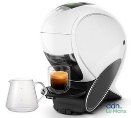 a white coffee machine with a cup of coffee next to it