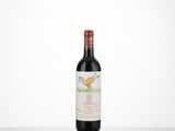 a bottle of red wine sitting on top of a table