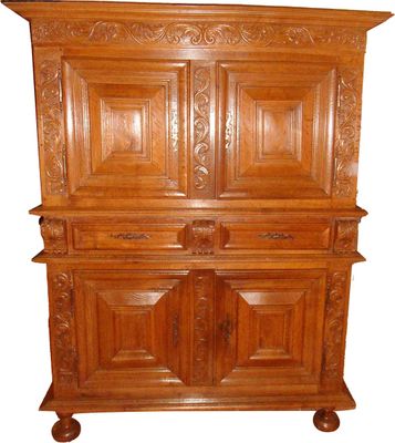 an old wooden cabinet with two doors on top of it