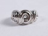 a close up of a silver ring on a white surface