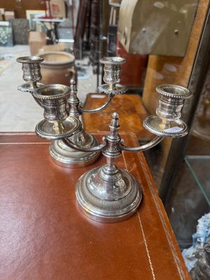 candlesticks on a table in a shop window display
