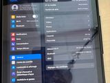 someone is writing on the screen of a tablet with a pen in their hand