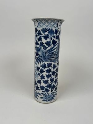 a blue and white vase with a bird on it