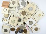 a pile of old coins on a white surface
