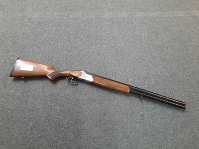a shotgun that is laying on a table