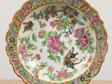 a plate with a bird and flowers design on it