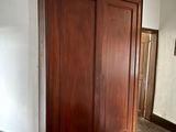 a large wooden armoire in the corner of a room