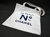 a white tote bag with a blue logo on it