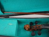 a violin in a case with a bow in it