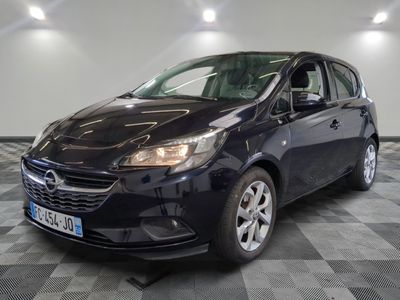 the black opel is parked on a checkered tile floor