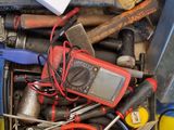 many tools in a blue bin with tags on them
