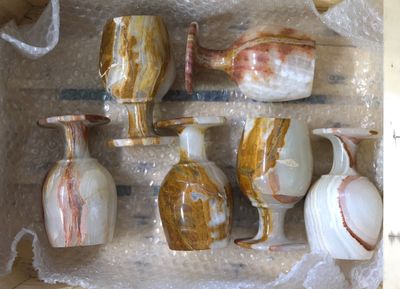 many different types of vases sitting in a box