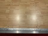 a wooden floor with a metal frame on top of it