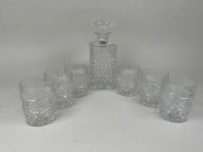 six glasses and a decanter on the table
