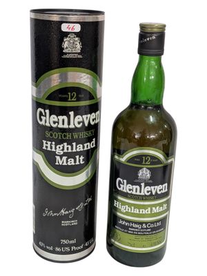 the bottle of glenlevd highland malt is next to the canister