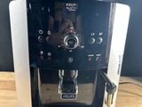 the coffee machine is sitting on the table ready to be used