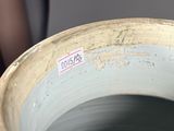 a close up of a vase with a label on it