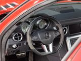 a steering wheel and dashboard of a red sports car