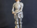 a statue of a man in a suit of armor