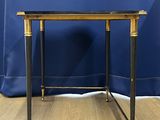 an image of a black and gold side table on a wooden floor