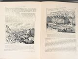 an open book with a picture of a city on it