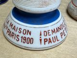 a white and blue bowl with a red inscription on it