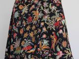 a black skirt with a floral pattern on it