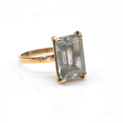 an image of a ring with a blue topaz stone