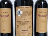 three bottles of wine that are sitting on a table
