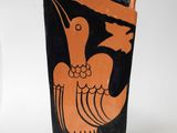 a black and orange vase with a bird on it