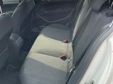 the back seats of a white car with a black seat belt
