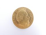 gold coin on a white background with a portrait of a man