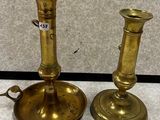pair of antique brass candlesticks on a white background