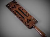 an old wooden rolling pin with holes and a wooden handle