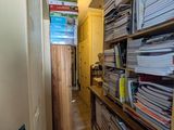 a narrow hallway with a lot of books on the shelves