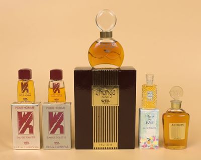 a bottle of perfume sitting on a table next to other bottles