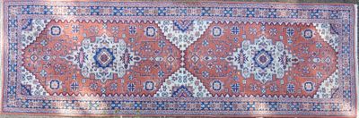 rug on the floor is red and blue with a pattern on it