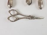 a pair of scissors and a pair of spoons on a table