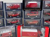 many different models of cars in boxes on the table