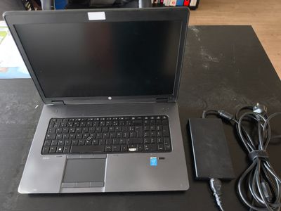 un ordinateur portable posé sur une table avec un chargeur