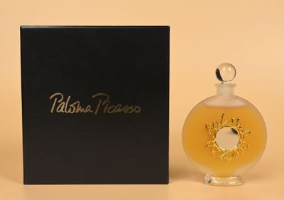 an image of a bottle of perfume sitting next to a box