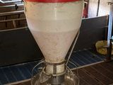 an image of a machine that is pouring milk into a container