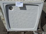 a white refrigerator sitting on a pallet with a price tag on it