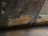 a rusted piece of metal with a label on it
