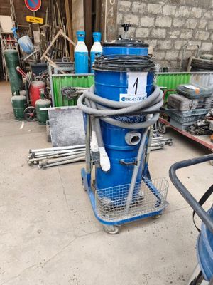 an image of a blue dust collector in a garage