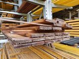 several pieces of wood are stacked on top of each other in a warehouse